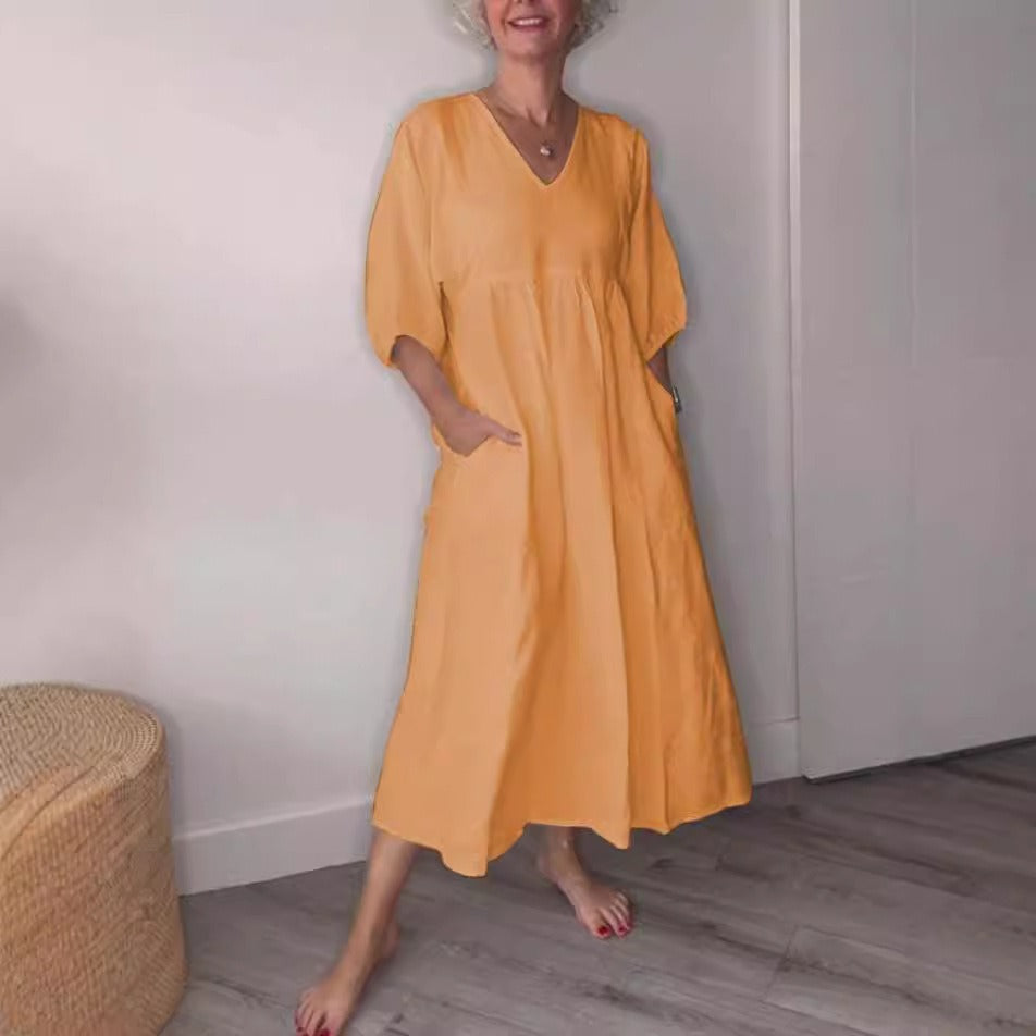 Women's relaxed midi dress in cotton linen with deep V-neck, cuffed sleeves, and side pockets