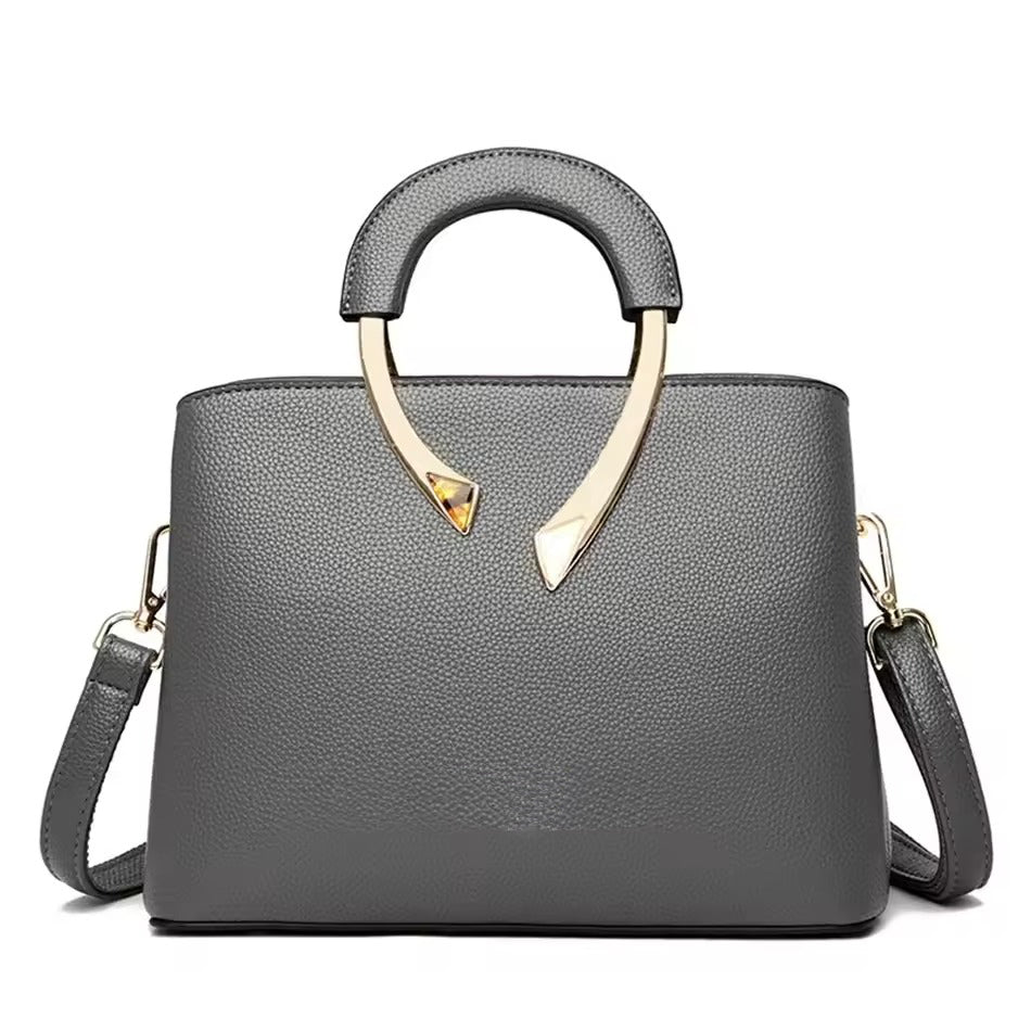 Structured pebbled faux leather handbag with gold metal handle, polished everyday professional style