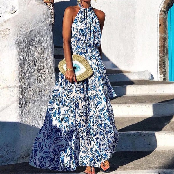 Women's floral print halter neck maxi dress with flowy tiered skirt for summer elegance