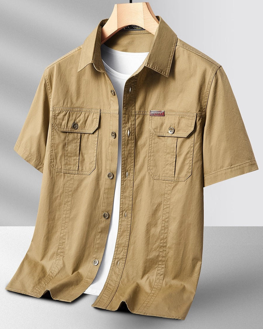 Olive green short-sleeve cargo shirt with flap pockets, crisp collar, and breathable cotton-blend fabric