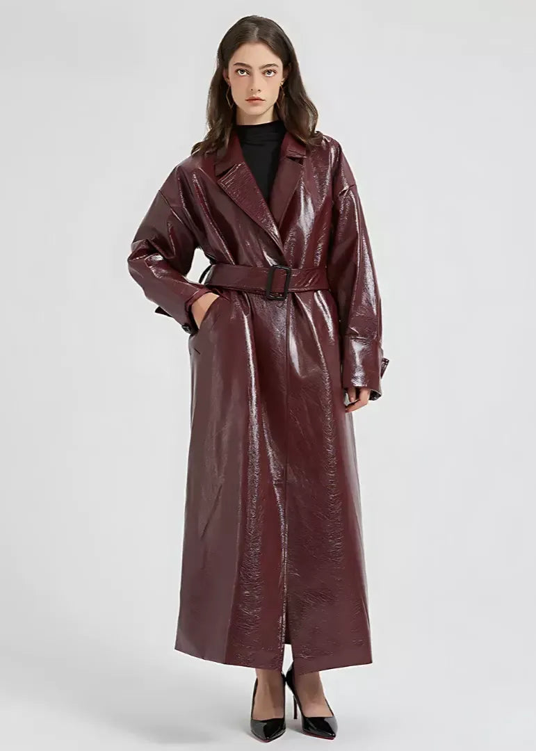 Glossy vegan leather women's slim fit full-length belted trench coat in sleek black professional style