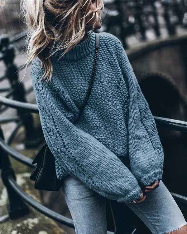 Women's oversized chunky knit turtleneck pullover sweater with eyelet details for a cozy modern look