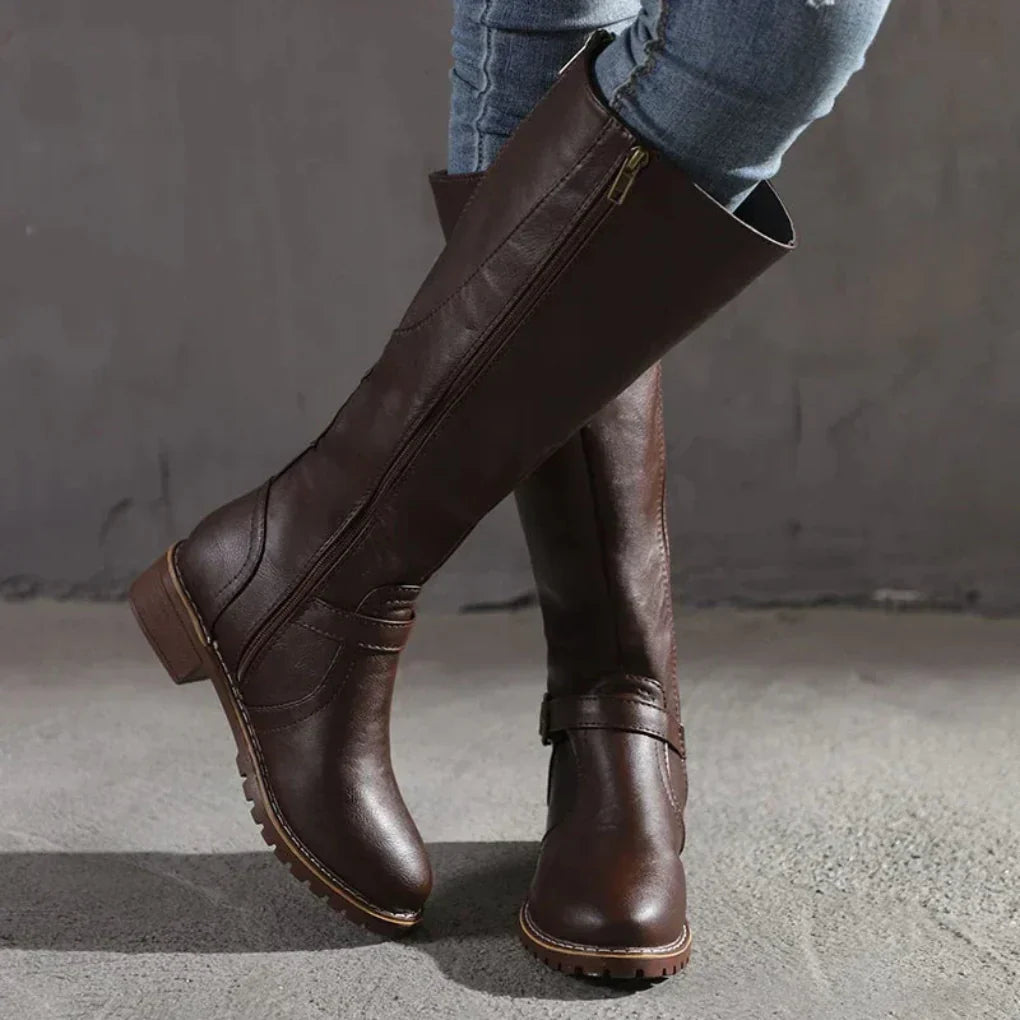 Women's black knee-high buckled boots sleek silhouette with decorative buckle accent