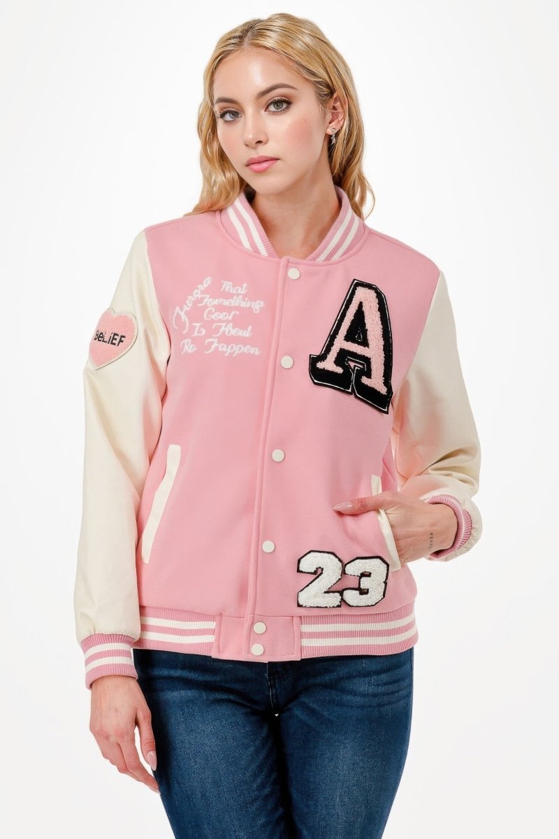 Black varsity bomber jacket with embroidered patches, streetwear cut and bold functional pockets