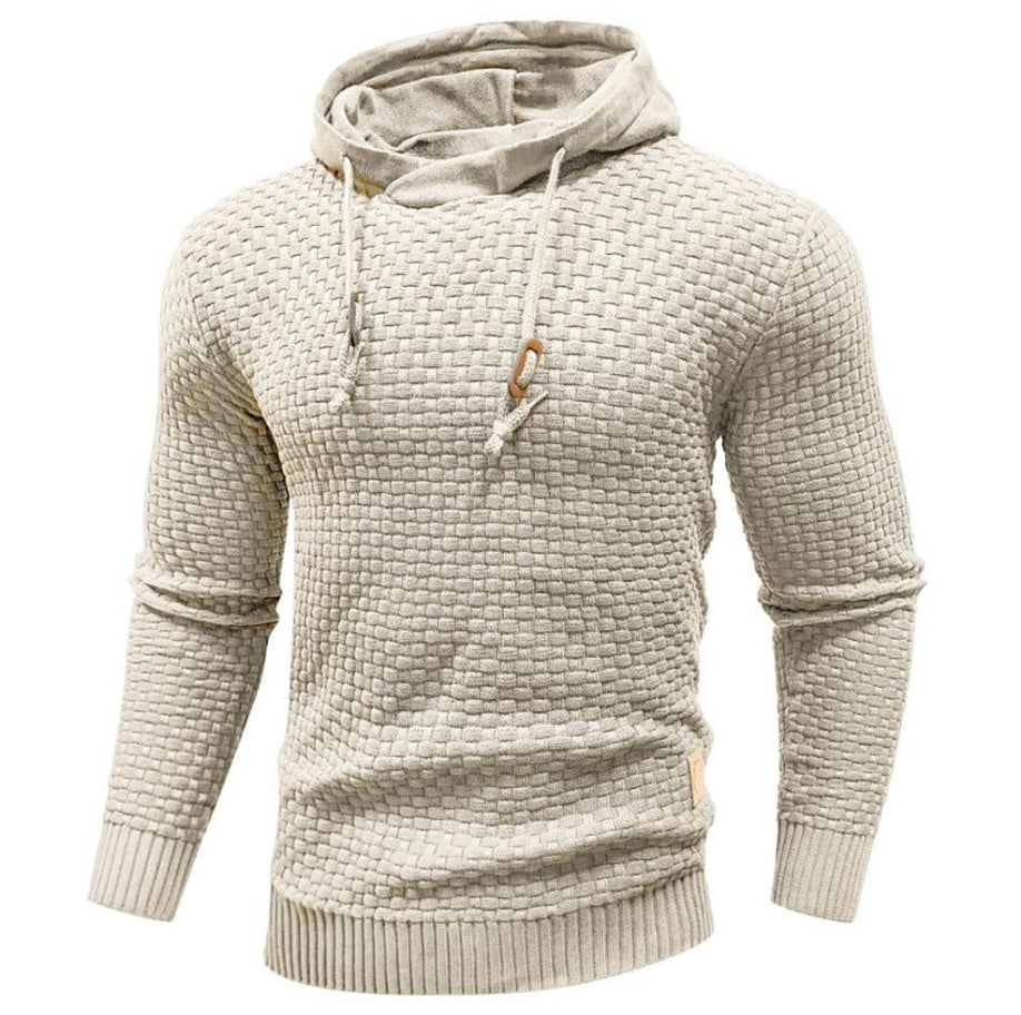 Men's textured knit hoodie in neutral tone, grid-woven pattern, relaxed silhouette, premium tactile finish
