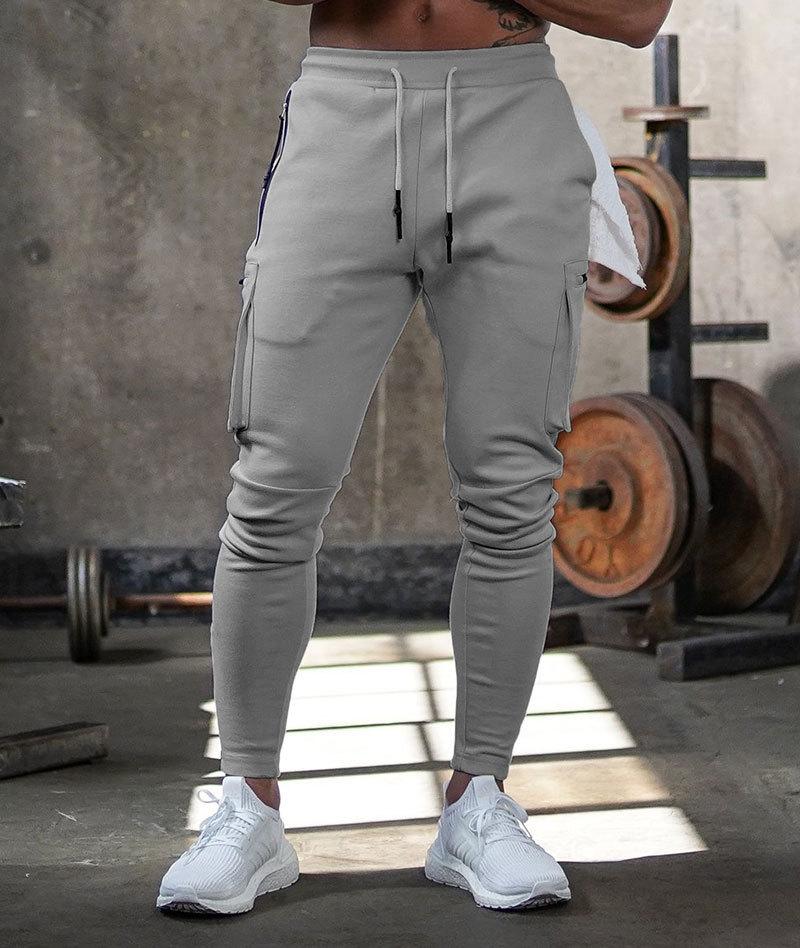 Men's gray athletic joggers with 4-way stretch fabric, tapered fit, and moisture-wicking performance