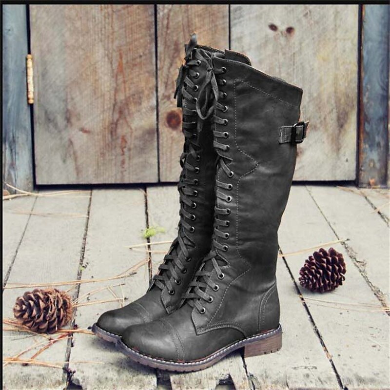 Women's tall black lace-up knee-high boots with structured silhouette for elongated flattering look