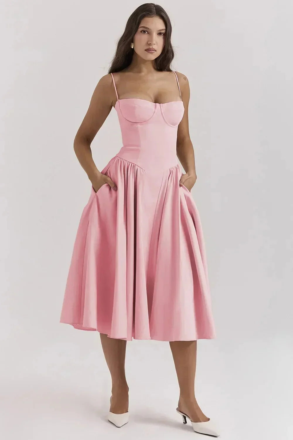 Elegant pleated midi dress with structured bodice, slim straps, flared skirt, and hidden pockets