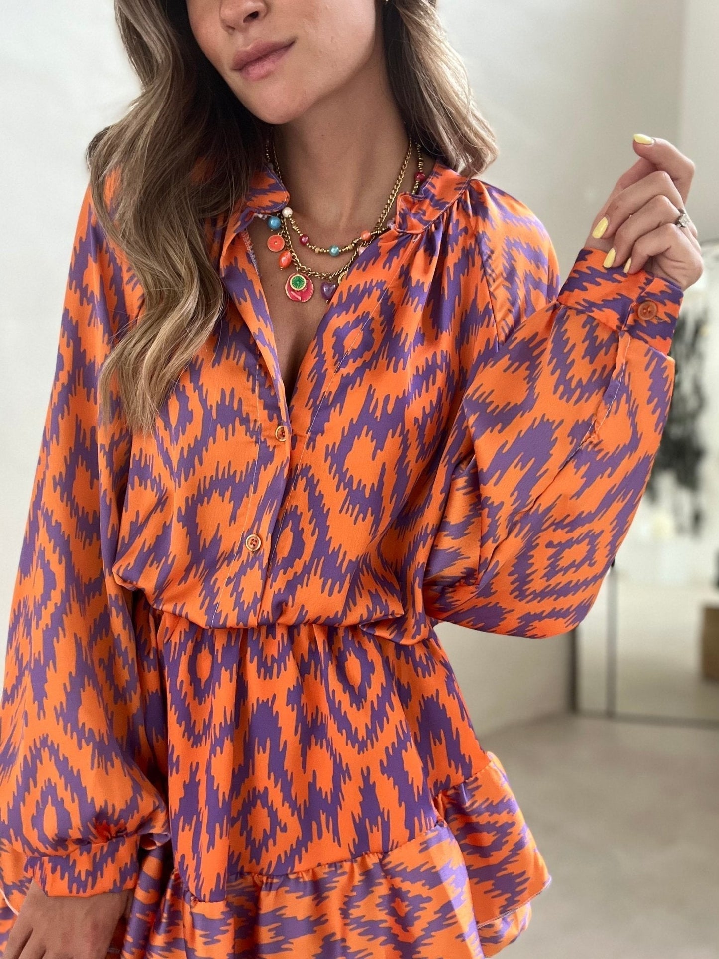 Floral mini dress with split V-neckline, ruffle trim, long sleeves, elastic waist, lightweight spring style