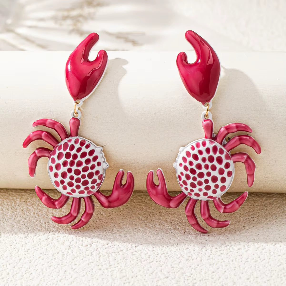 Hand-painted enamel crab claw drop earrings, lightweight sculptural silhouette in vibrant multicolor finish