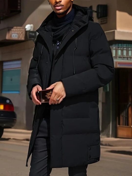 Men's long black puffer coat with hood, zip closure, extended length silhouette for winter layering
