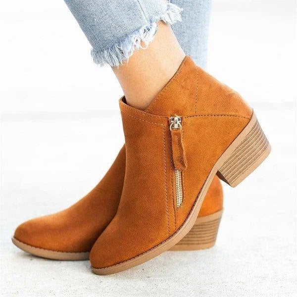 Women's black orthopedic ankle boots with side zipper, supportive insole, and classic silhouette