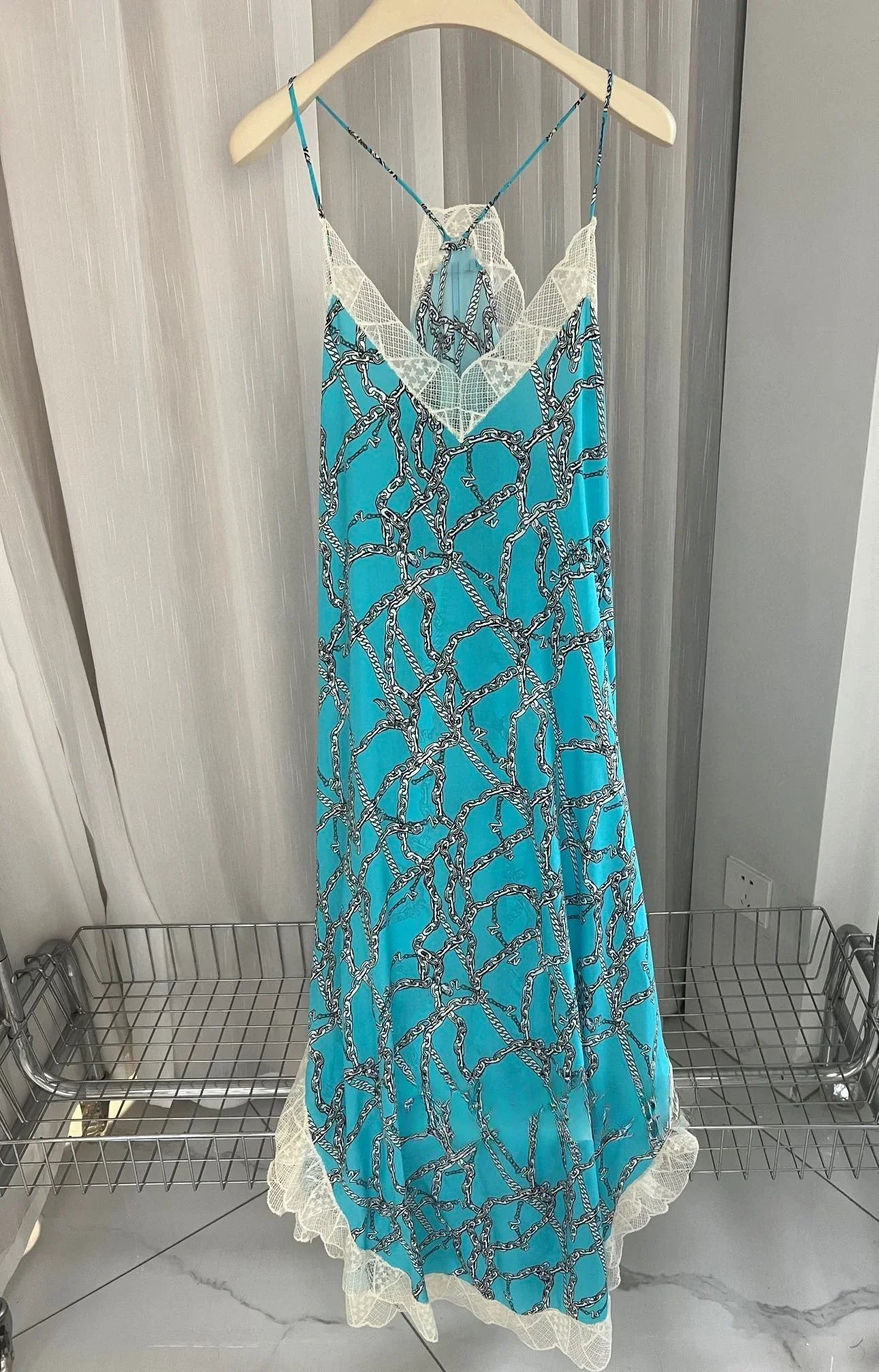 Ivory silk midi dress sleeveless V-neck silhouette with delicate lace embroidery flowing sophisticated style