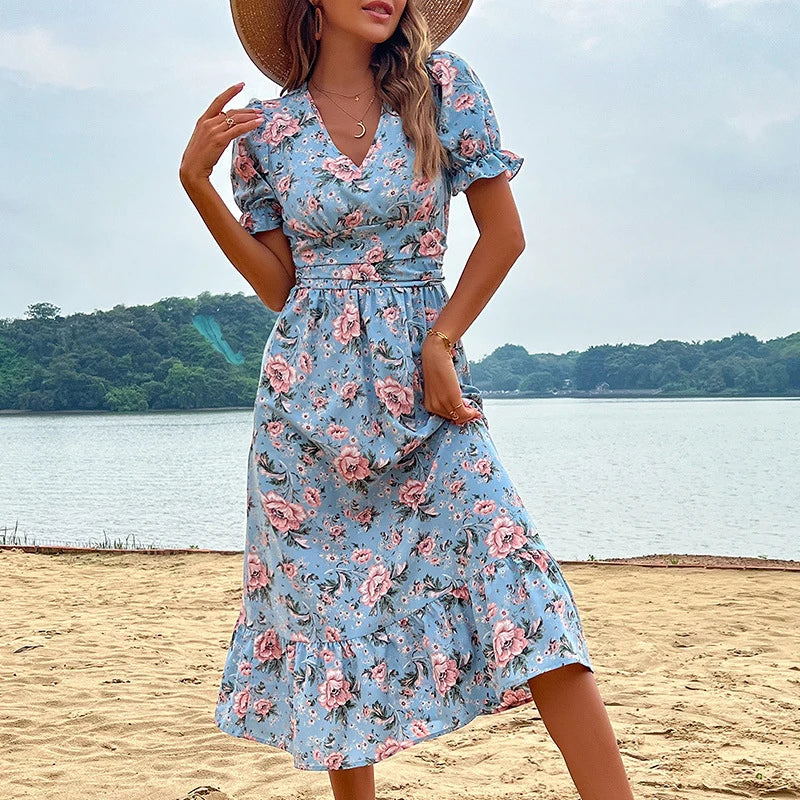 Floral print midi dress with V-neck, puff sleeves, fitted waist, and ruffle hem in romantic feminine style