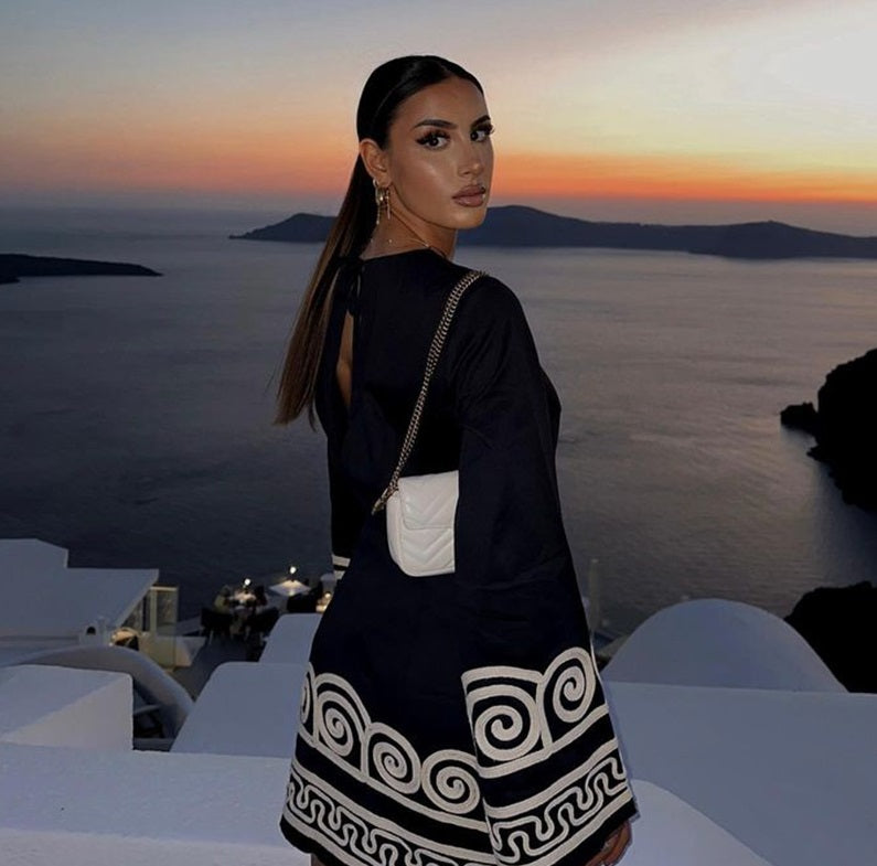 Loose fit mini dress with long flared sleeves and geometric embroidery on cuffs and hem