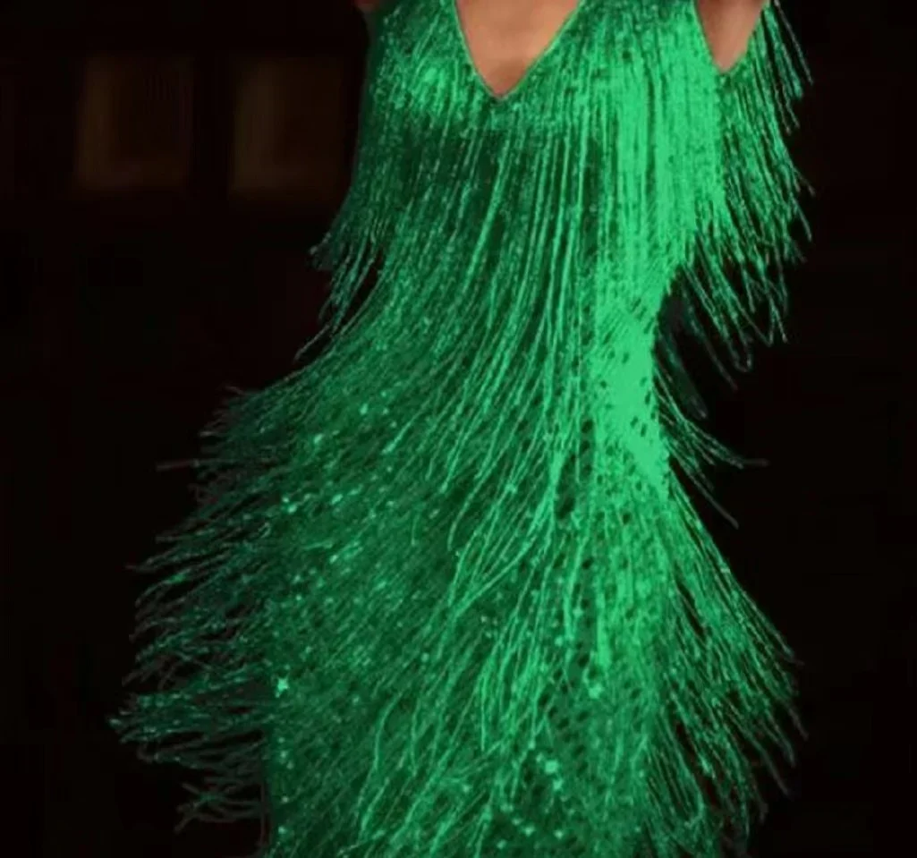 Black sleeveless form-fitting cocktail dress with shimmering polyester fringe detailing for nightlife