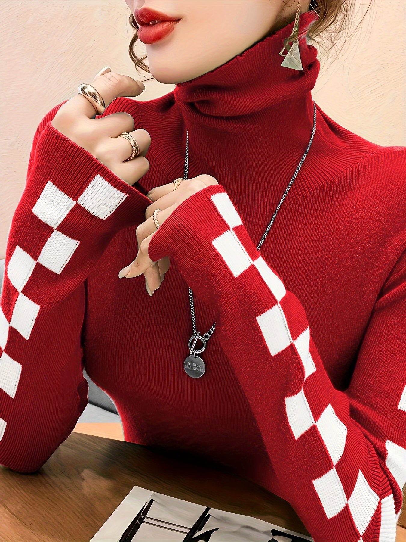 Women's white turtleneck sweater with bold checkerboard sleeves, cotton-blend ultra-soft knit