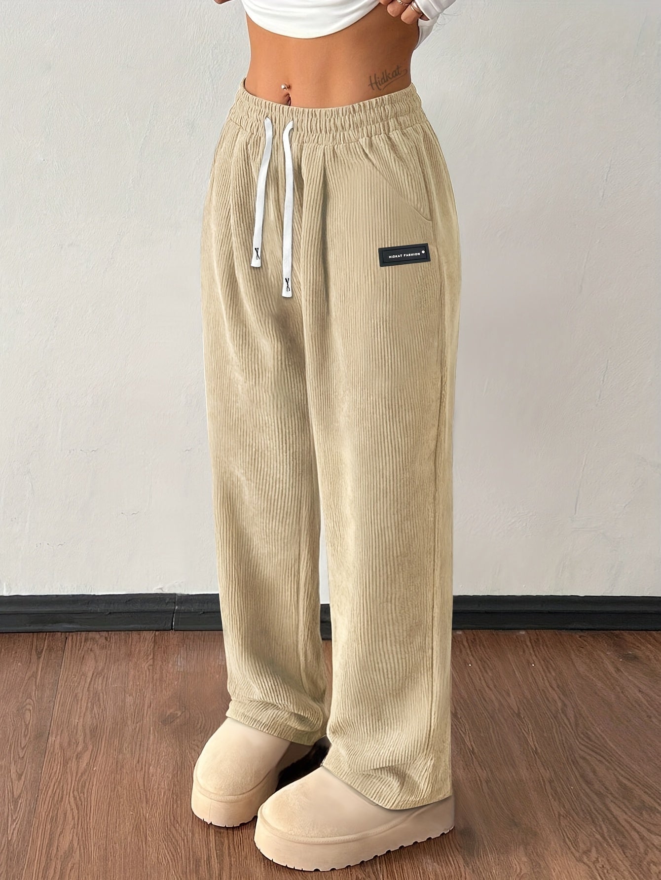Women's brown corduroy wide-leg jogger pants with high-rise drawstring waist and deep pockets