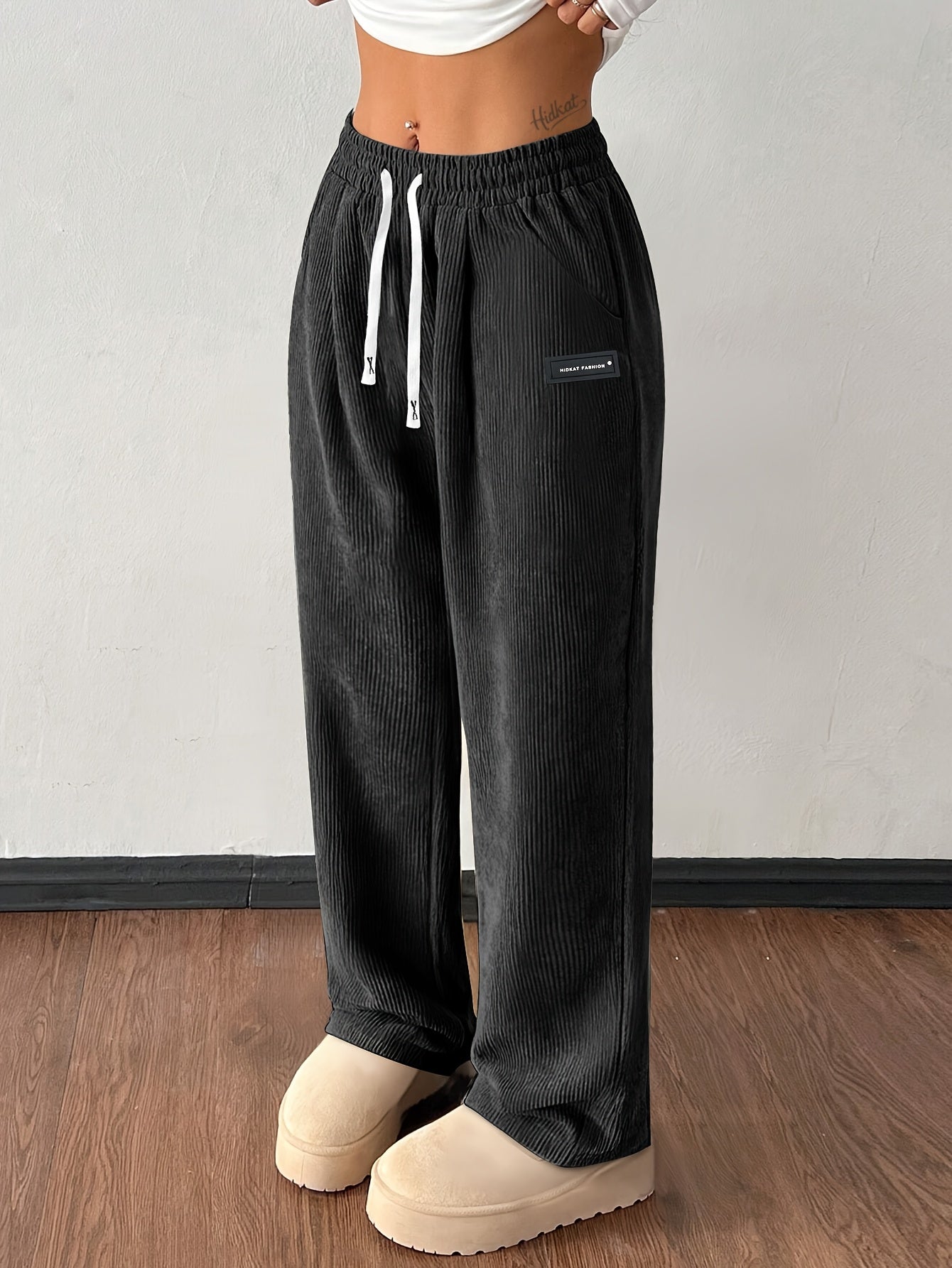 Women's brown corduroy wide-leg jogger pants with high-rise drawstring waist and deep pockets