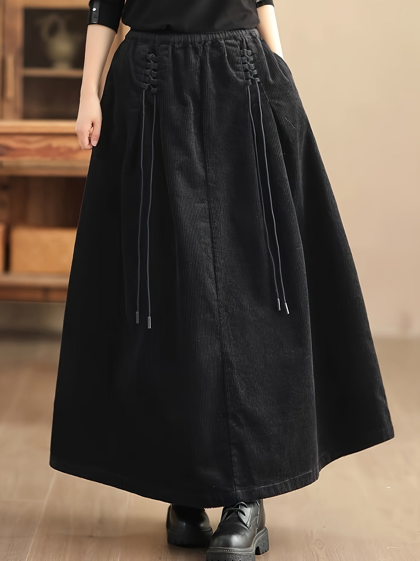 Women's brown corduroy maxi skirt with corset waist, wide A-line silhouette, and deep pockets
