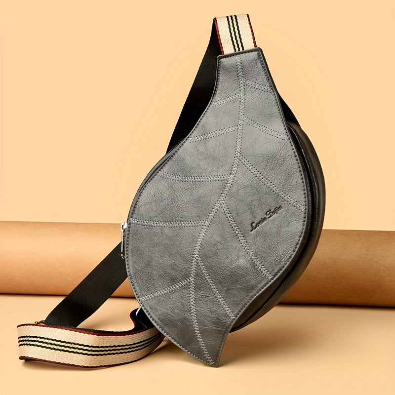 Vegan leather leaf-shaped crossbody bag with embossed vein detailing and striped strap