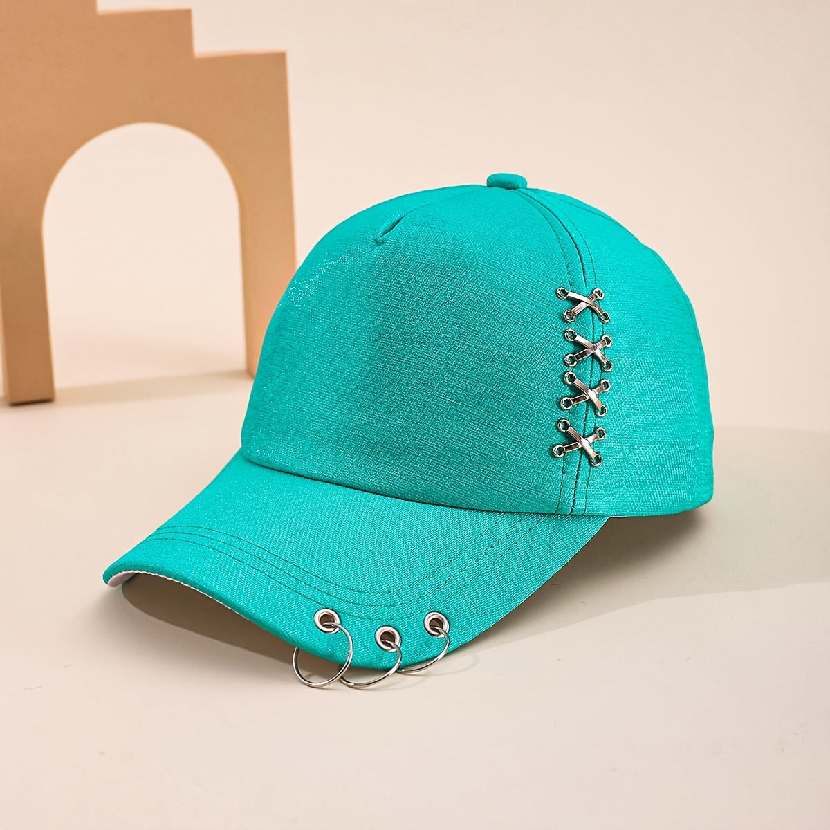 Unisex structured black cap with stainless steel lace-up hardware and triple front ring streetwear detail