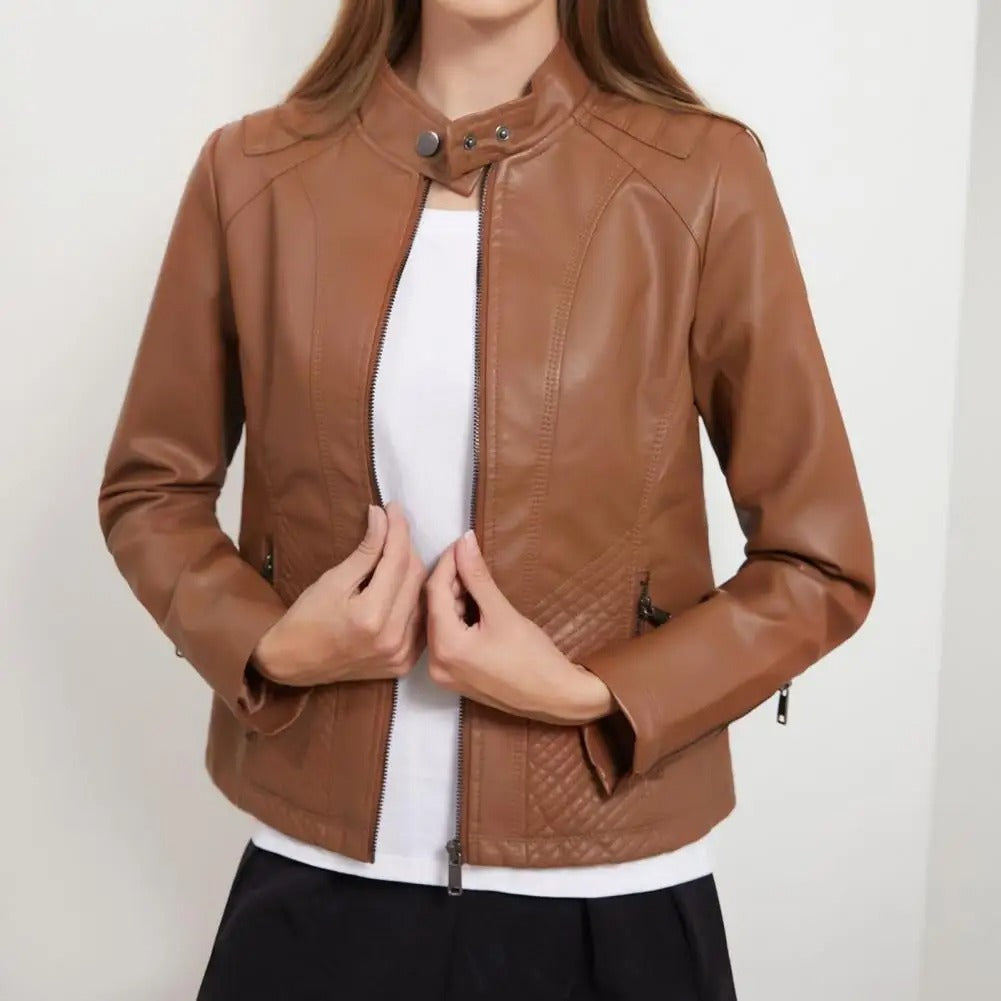 Women's black moto jacket with stand collar, quilted side panels, and snap-tab closure
