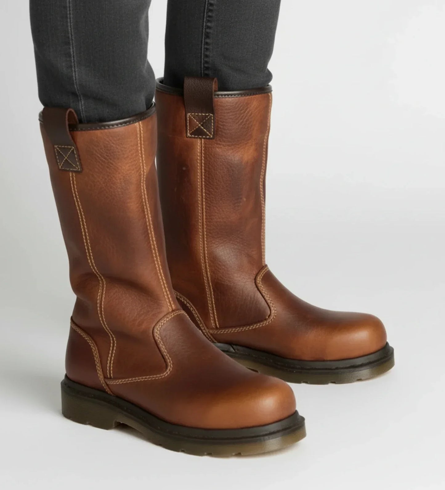 Men's brown full-grain leather pull-on work boots with lug sole and faux fur trim for outdoor use