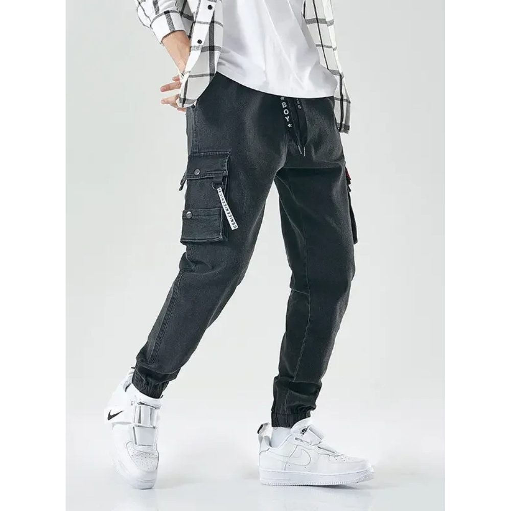 Men's blue denim cargo joggers with elastic waistband, tapered fit, and multiple utility pockets