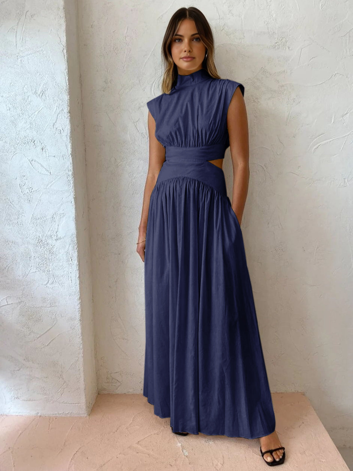 Black mock neck cutout maxi dress with sleeveless silhouette and structured neckline for day-to-night wear