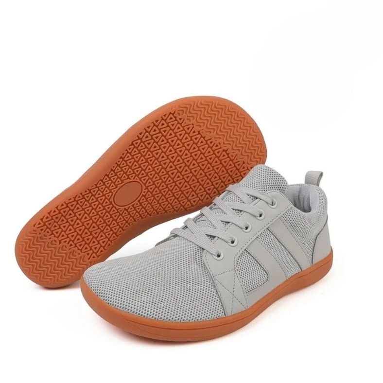 Men's white minimalist leather sneakers with breathable textile panels and clean low-top silhouette