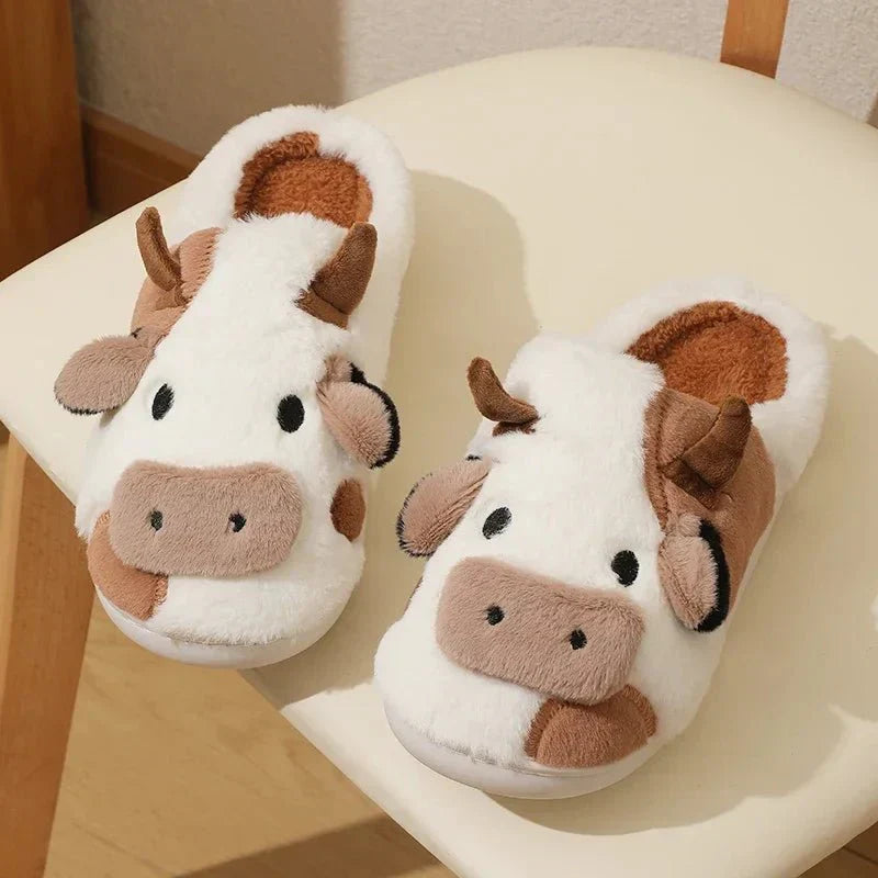 Women's cow print plush slippers with soft lining, playful black-and-white animal pattern cozy gift