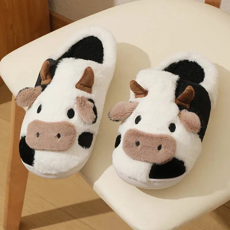 Women's black and white cow pattern plush-lined slippers with cozy cushioning for everyday home comfort