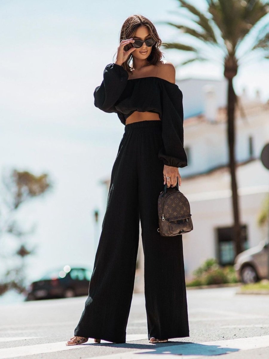 Elegant black off-shoulder draped two-piece top and pants set with long sleeves for women