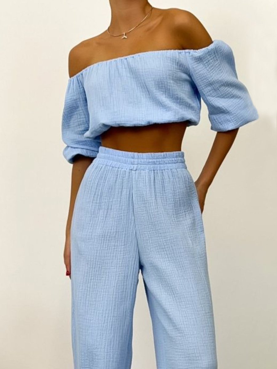Elegant black off-shoulder draped two-piece top and pants set with long sleeves for women