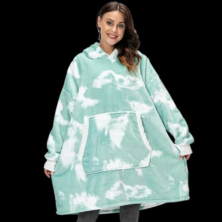 Oversized wearable blanket hoodie in plush neutral tones with giant cozy fit and built-in hood