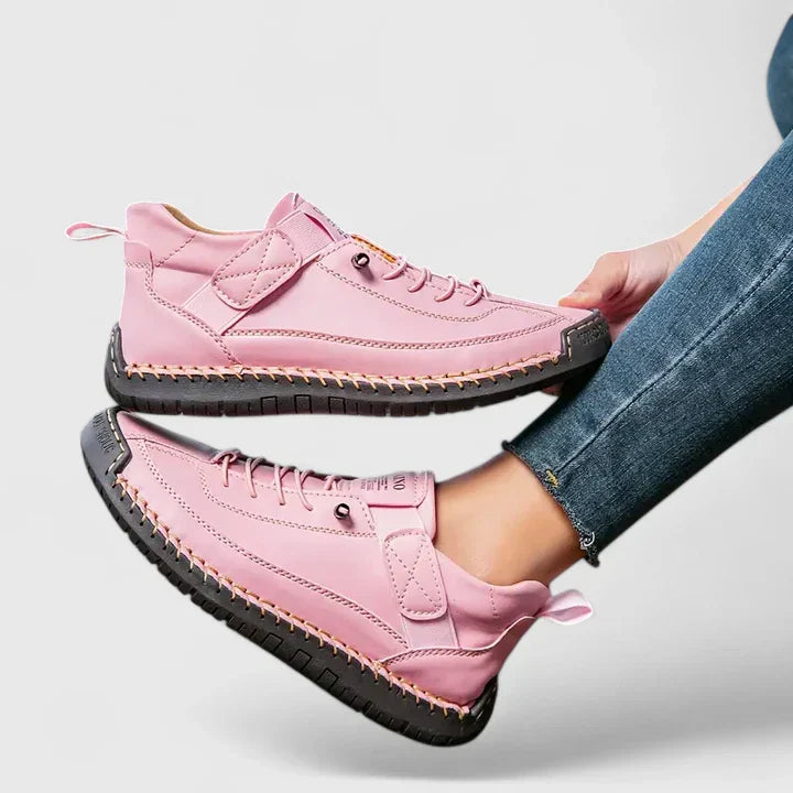 White high-top sneakers with stitched panels, lace-up front, adjustable strap, and structured urban silhouette