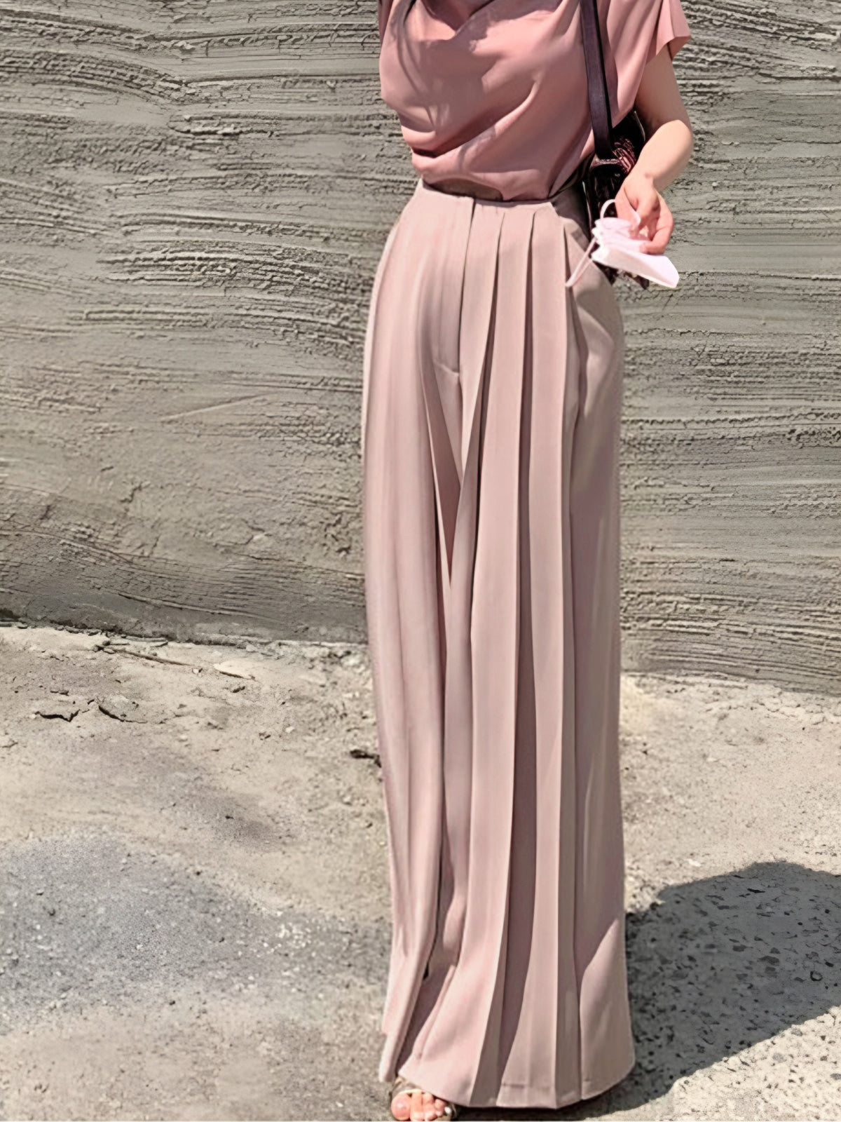 Beige pleated high-waist wide-leg trousers with crisp woven fabric, elegant fit for work or occasions