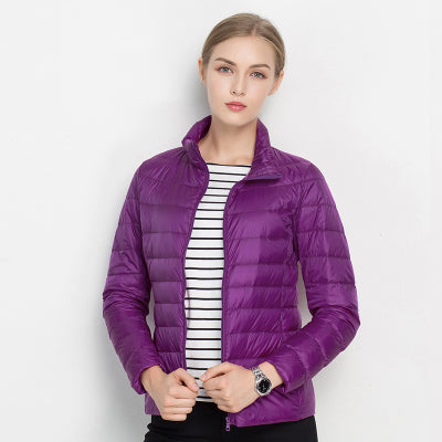 Navy slim-fit lightweight quilted jacket with high collar, horizontal panels, unisex wind protection