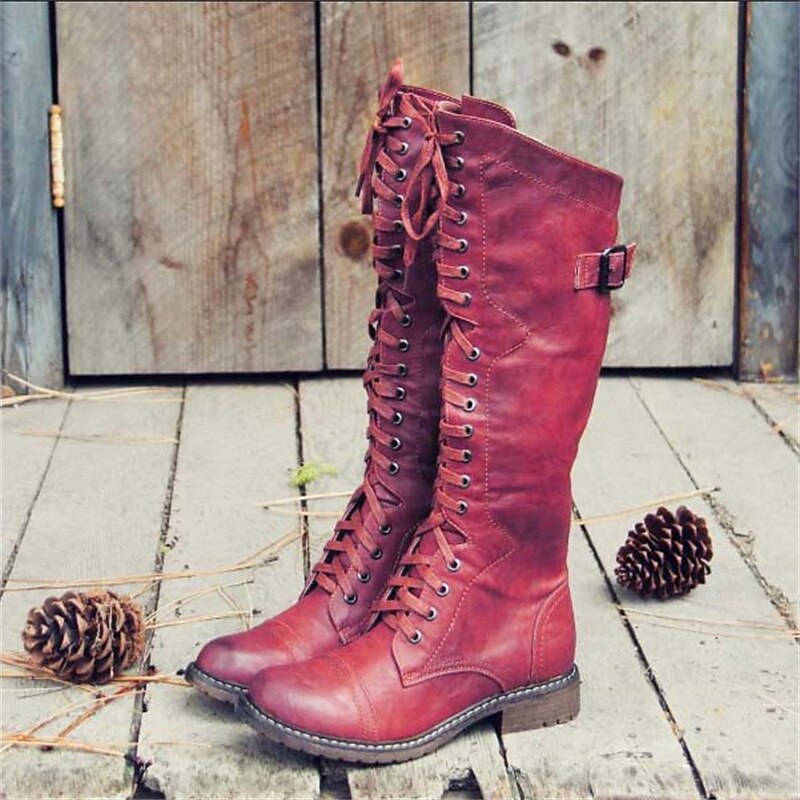 Women's tall black lace-up knee-high boots with structured silhouette for sophisticated style