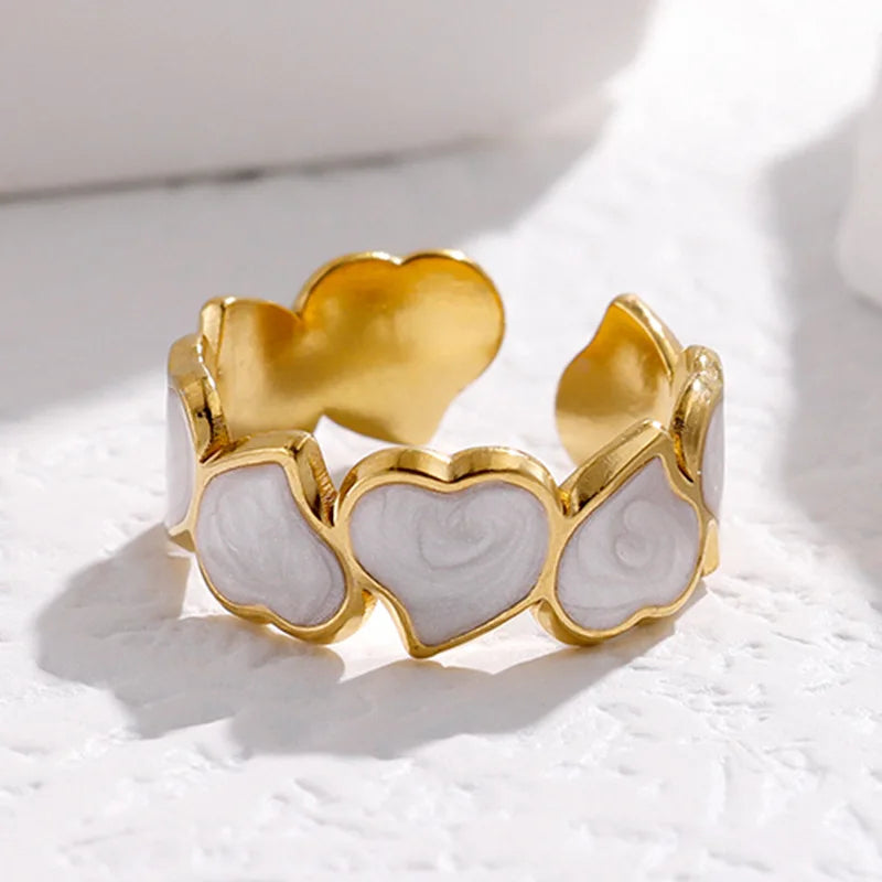 Adjustable stainless steel heart link ring with glossy enamel hearts in pearl white or jet black