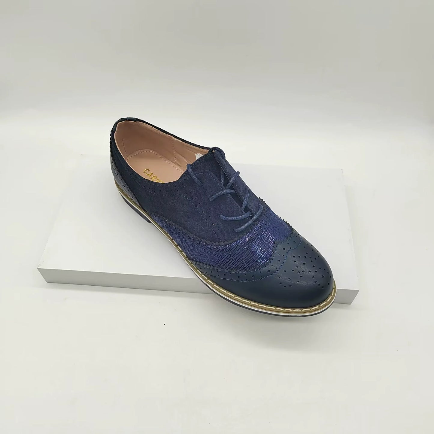 Women's brown faux leather brogue shoes with lace-up closure and classic perforated detailing