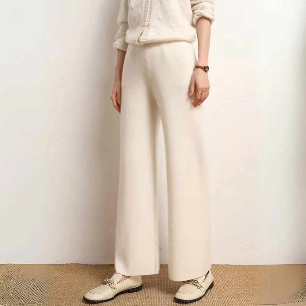 Neutral wide-leg knitted wool cashmere trousers with relaxed drape for cozy office style