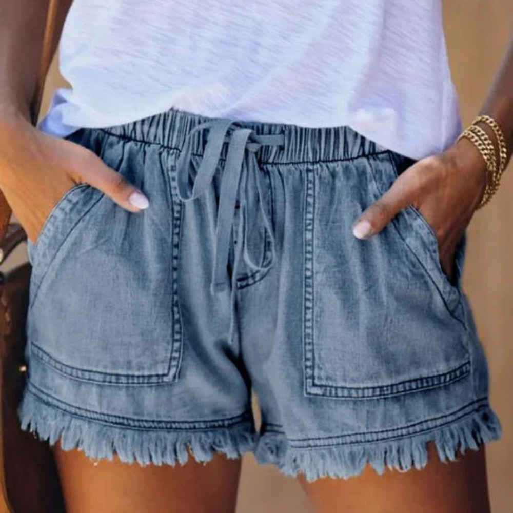 Women's high waisted blue denim shorts casual fit with drawstring waist and fringed hem