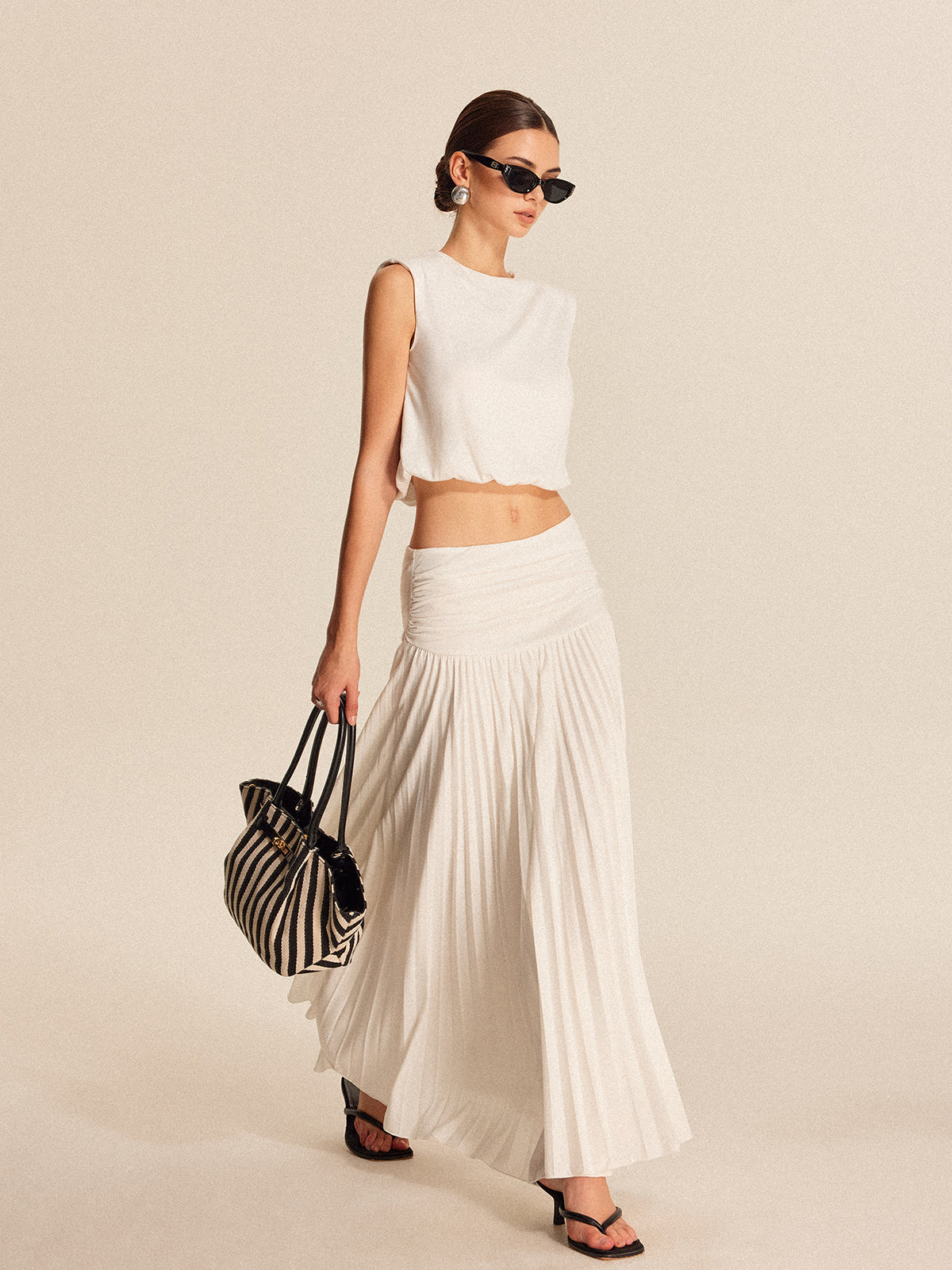 Women's chic pleated skirt set with shoulder pads, button details, lightweight jersey fabric