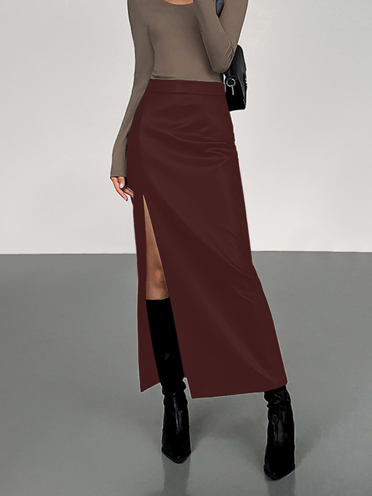 Black PU faux leather midi skirt with dramatic side split, sleek structured silhouette