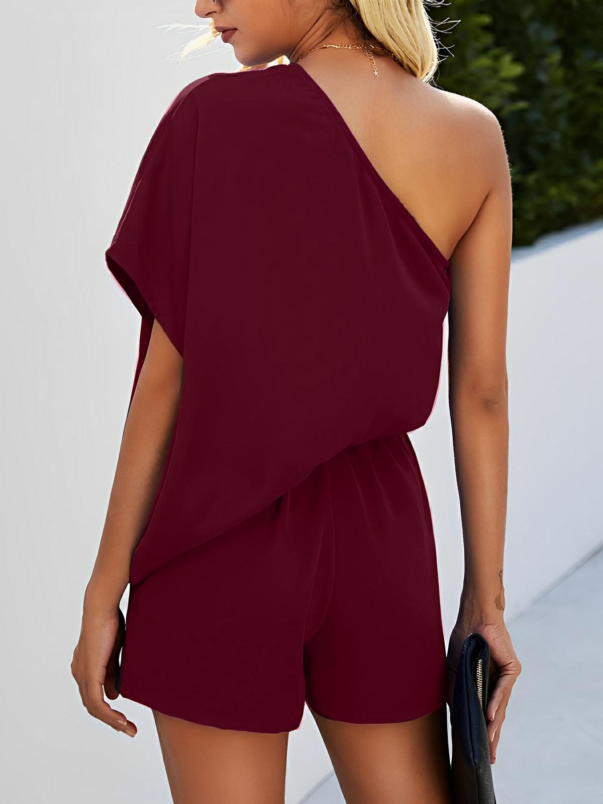 Black single-shoulder batwing sleeve romper with asymmetrical silhouette for bold evening wear
