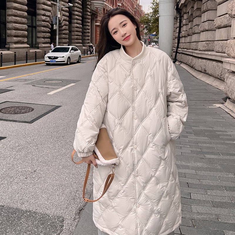 Oversized down jacket in neutral tones, relaxed fit with lightweight insulation for cold weather layering