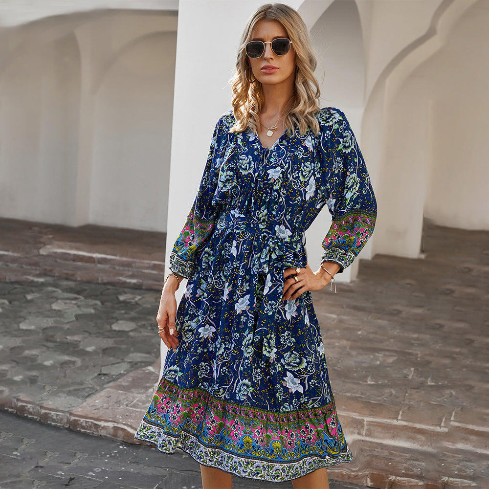 Boho floral mini dress with empire waist V-neck, flowing silhouette in vibrant multicolor print