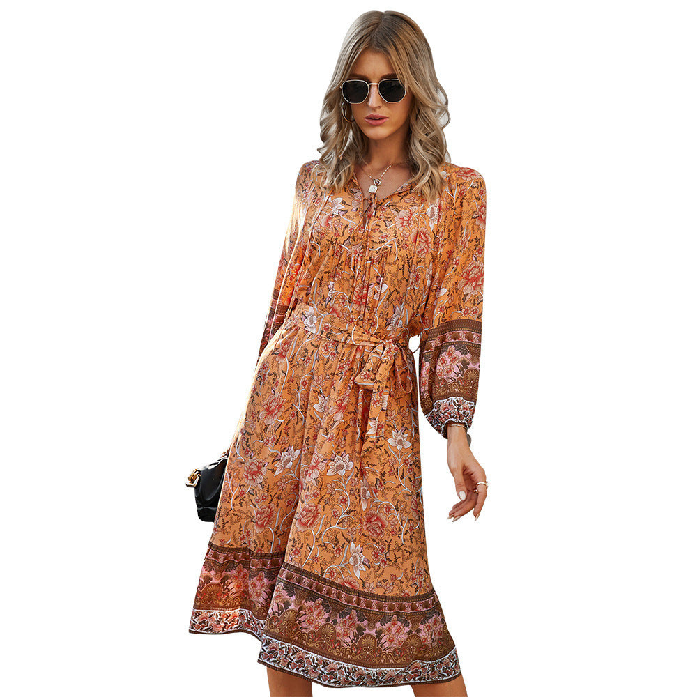 Boho floral mini dress with V-neck, empire waist, and flowing silhouette for free-spirited women